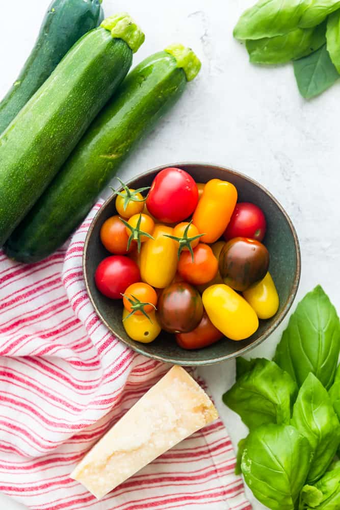 ingredients for the dish: zucchini, tomatoes, basil, pasrmesan cheese