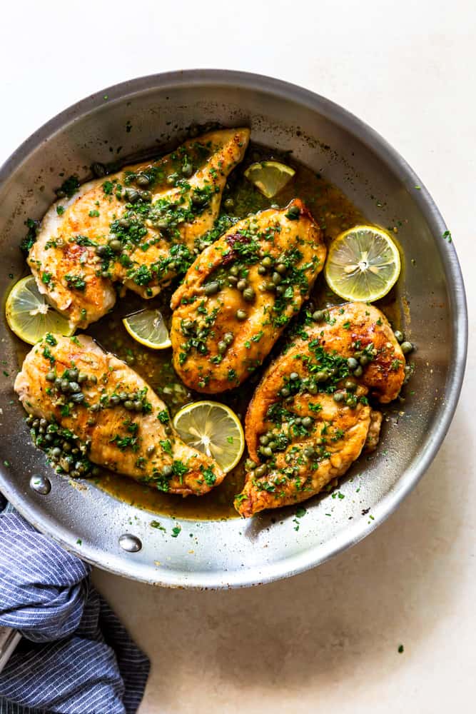Chicken piccata with capers and lemon in a pan