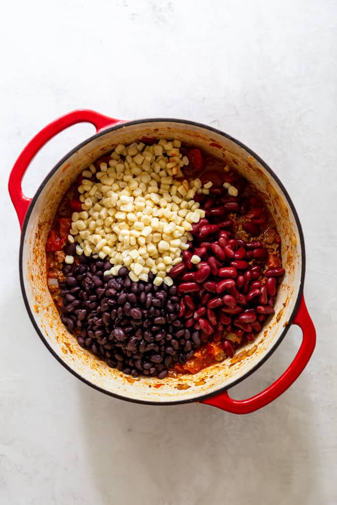 Black beans, kidney beans and corn in a red dutch oven