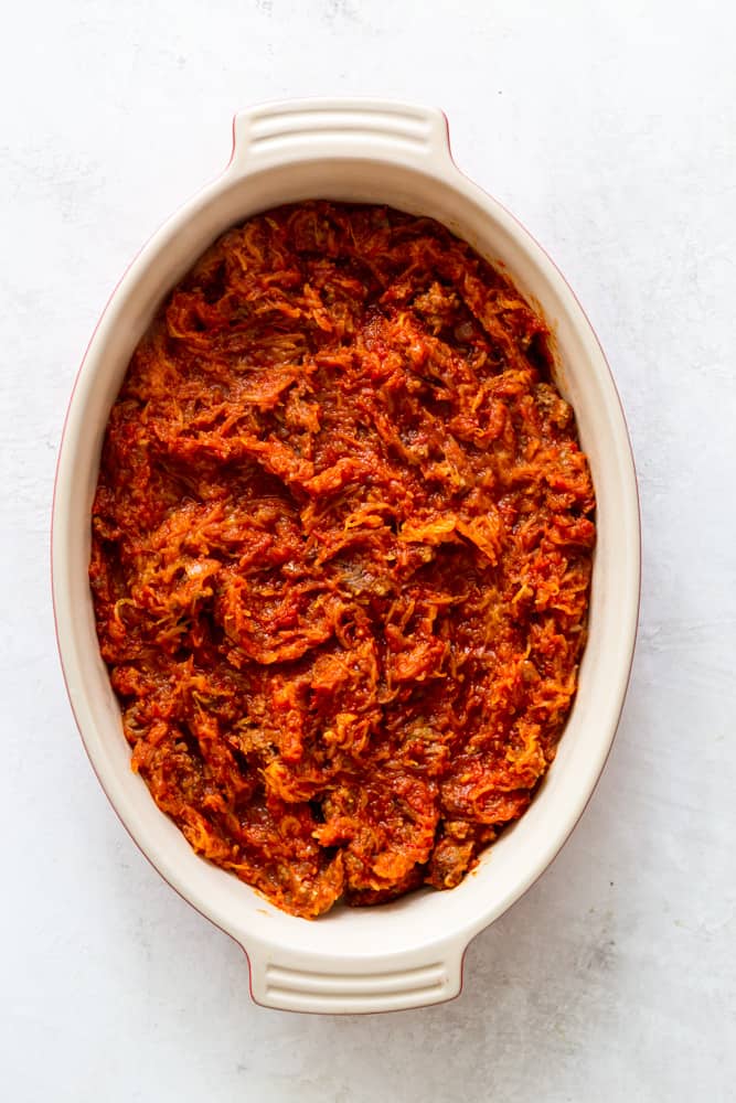 Spaghetti squash mixed with sauce in a casserole dish