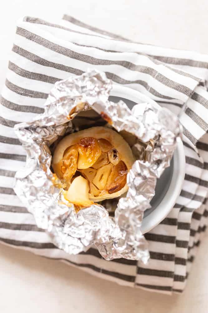 Roasted head of garlic wrapped in foil.