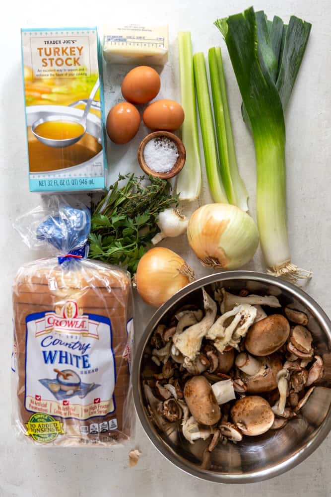 ingredients for mushroom stuffing: turkey stock, eggs, butter, salt, pepper, celery, leek, fresh herbs, garlic, onions, mushrooms, bread.