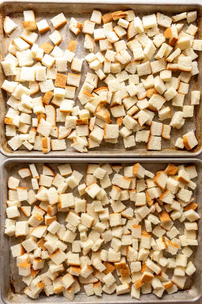 Cubed bread on two baking sheets