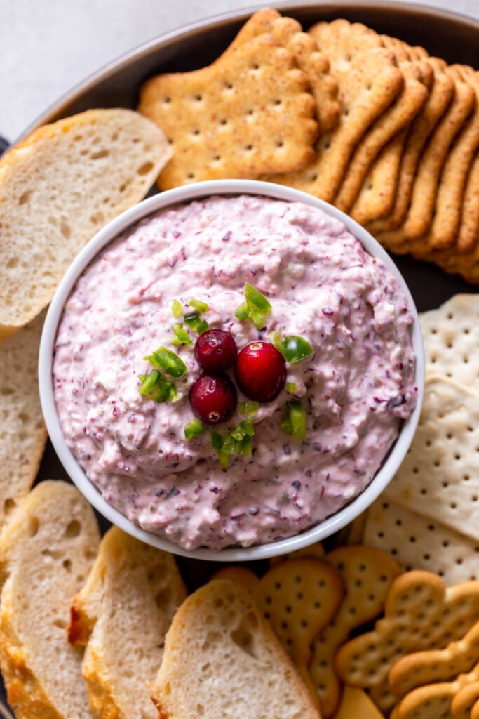 Cranberry jalapeno dip on a plate with crackers