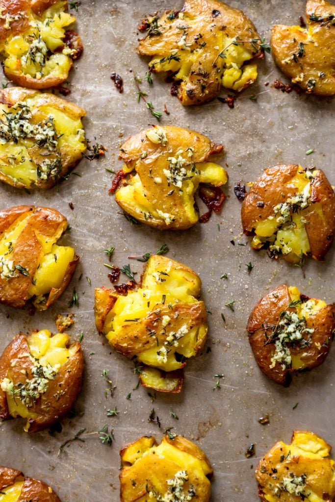 Crispy smashed potatoes on a baking sheet