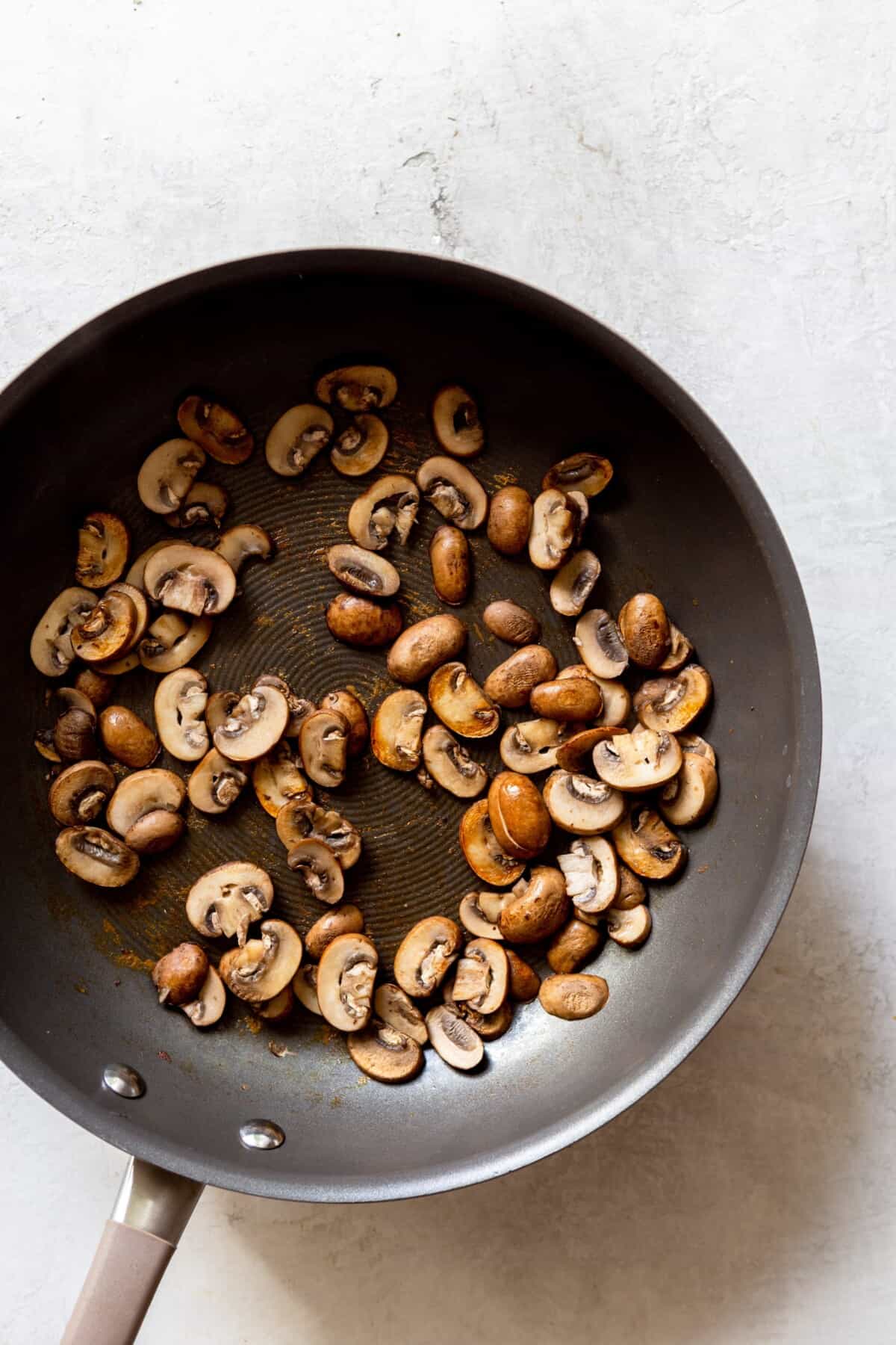 cooked sliced mushrooms in a pan
