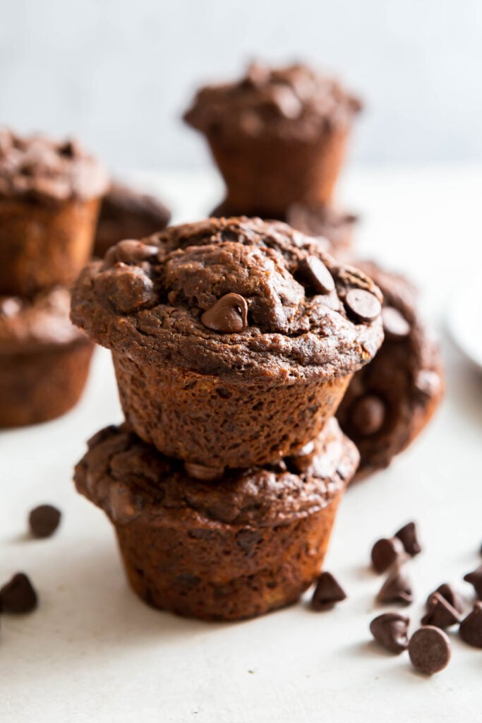 Two Chocolate banana muffins stacked on top of each other.
