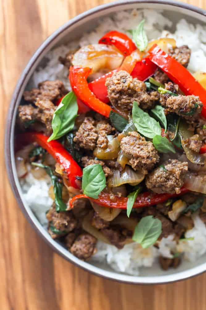 Thai basil beef with fresh basil, red bell peppers and onions over white rice.