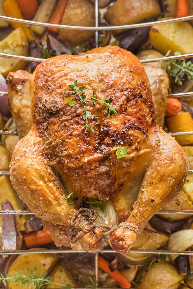 Roasted chicken with thyme sprigs, in a roasting pan