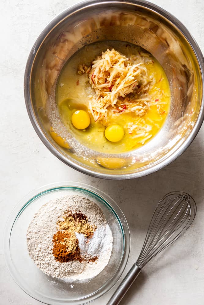 Two bowls, on with wet ingredients and one with dry ingredients, before mixing together.