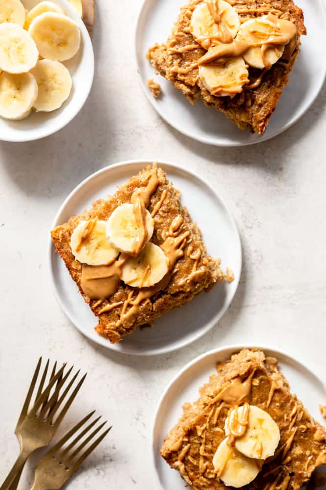 Peanut butter banana baked oatmeal square topped with more peanut butter and sliced bananas