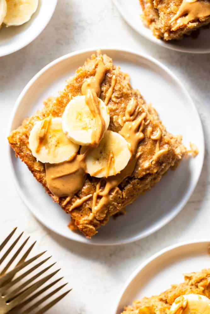 Peanut Butter Banana Baked Oatmeal topped with peanut butter drizzle and sliced bananas.