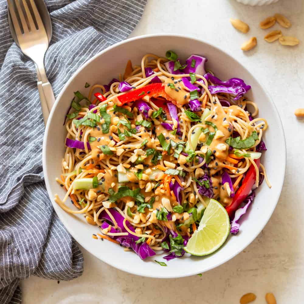 Cold peanut noodle salad in a white bowl