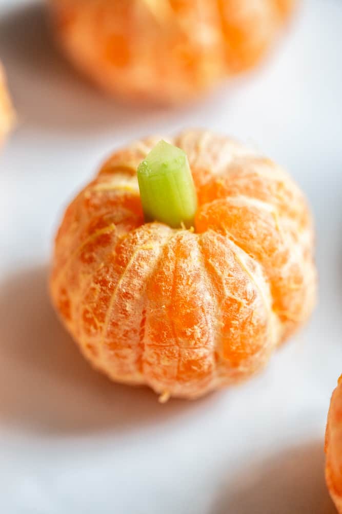 Clementine Pumpkin - a peeled clementine with a small piece of celery used as a stem.