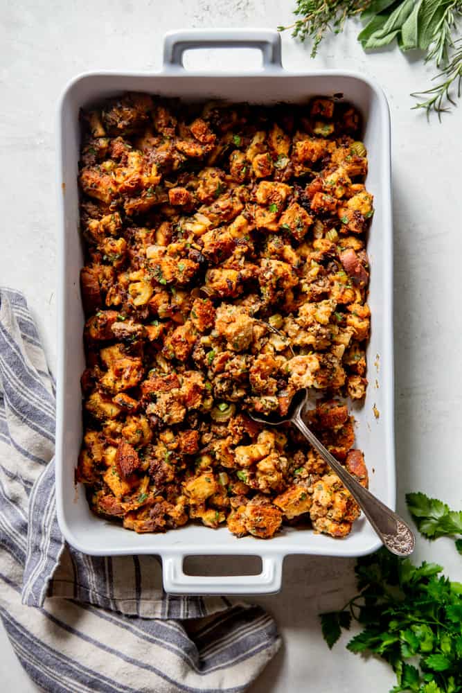Classic sausage stuffing in a white baking dish.