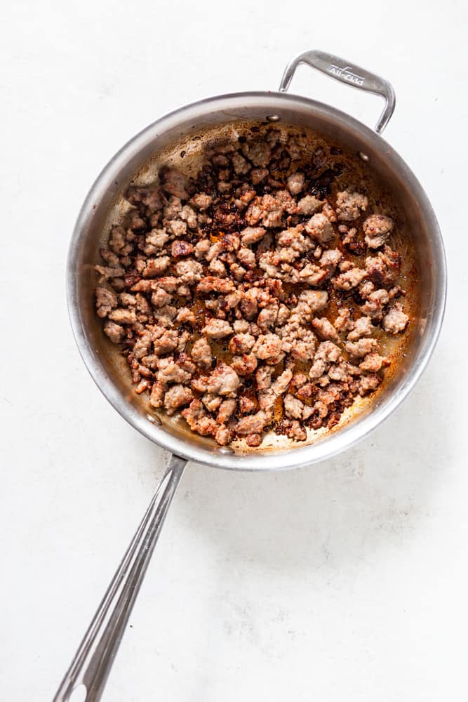 Sausage browning in a skillet.