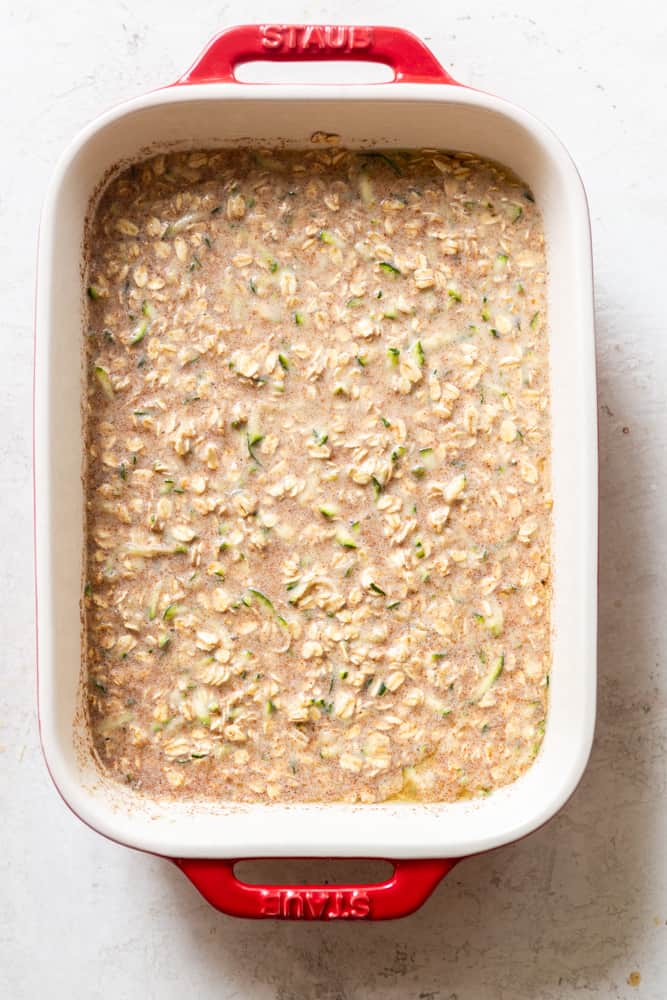 Zucchini Baked Oatmeal before being baked in a red ceramic 1.5 quart baking dish