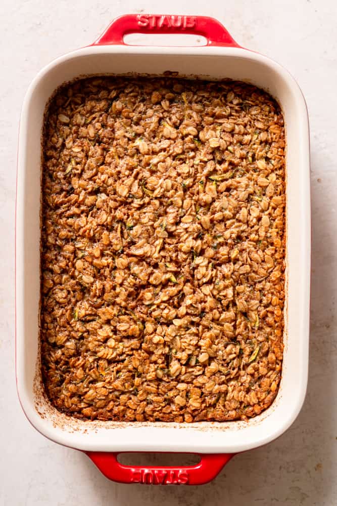 Zucchini Baked Oatmeal after being baked in a red ceramic 1.5 quart baking dish