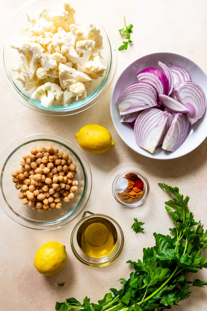 Ingredients for Cauliflower chickpea wraps: Cauliflower florets, sliced red onion, canned chickpeas, olive oil, spices, salt, parsley.
