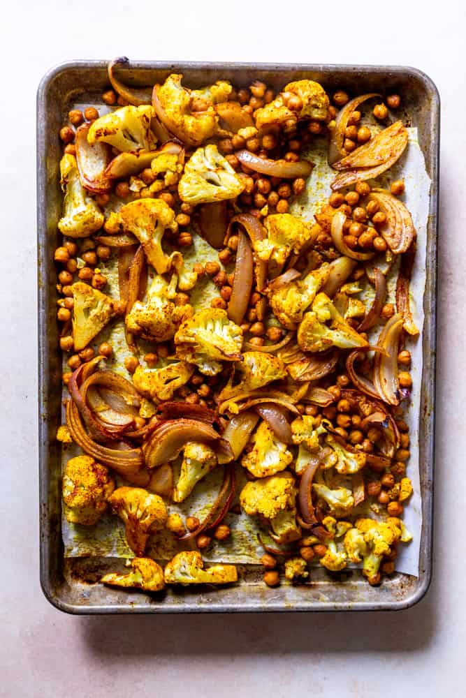 Sheet pan with spiced cauliflower, chickpeas and onion after roasting.