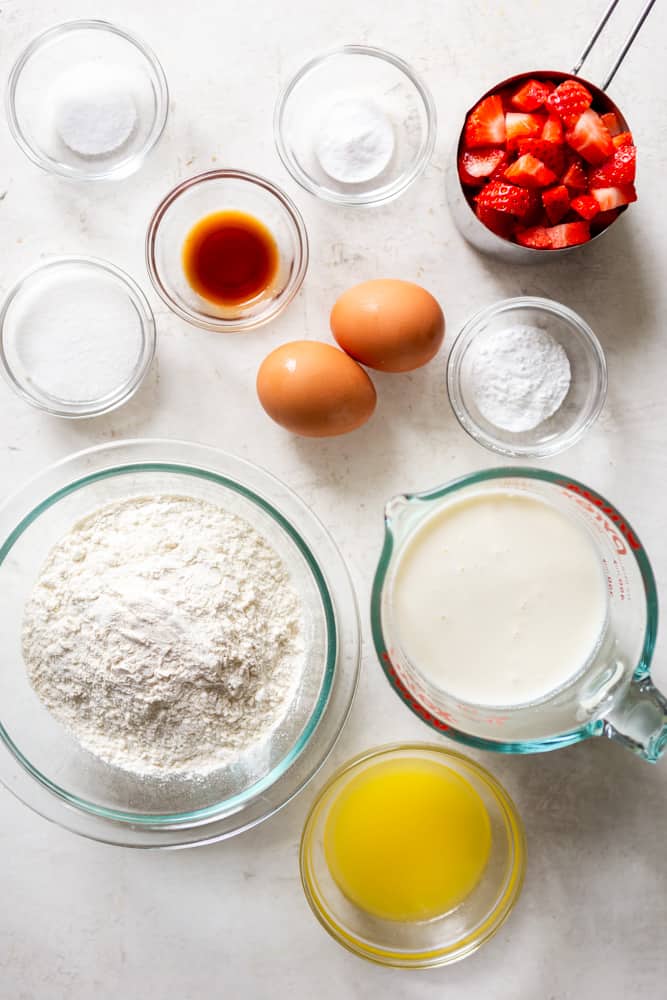Ingredients for strawberry pancakes: Flour, buttermilk, melted butter, eggs, baking soda, baking powder, salt, sugar, vanilla extract, chopped fresh strawberries