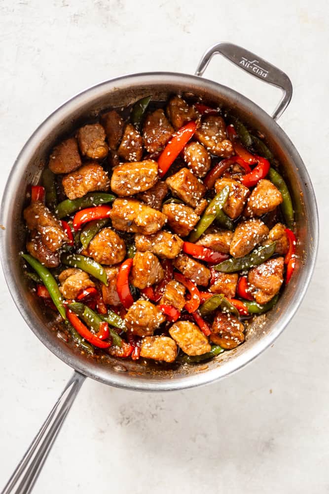 Honey garlic pork stir fry in a stainless steel saute pan.