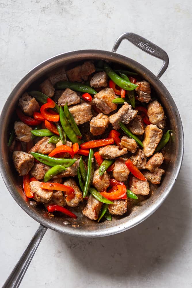 red bell peppers and snap peas added back to the pan after pork is browned.