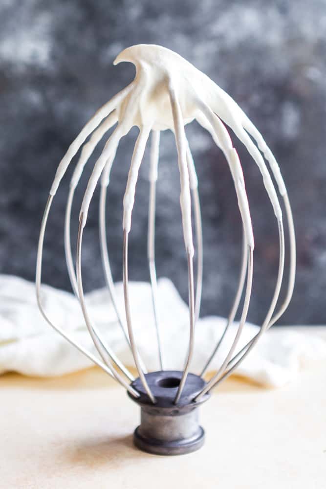 Homemade whipped cream on a whisk attachment. 