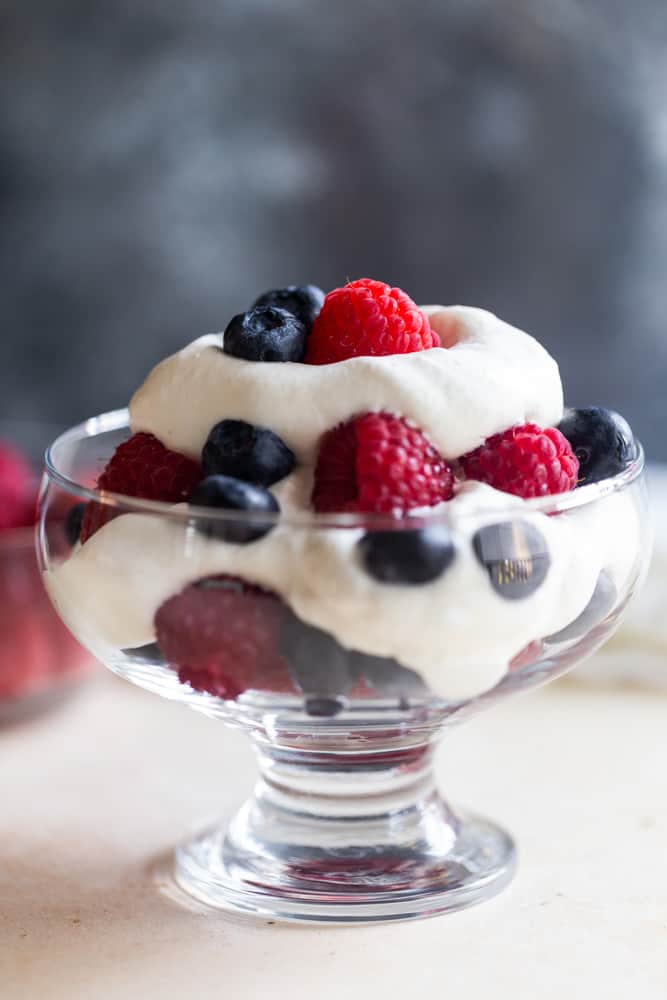 Fluffy homemade whipped cream with berries.