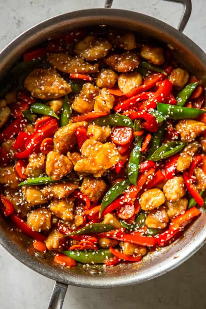 Honey Garlic Chicken Stir Fry in a pan garnished with sesame seeds.