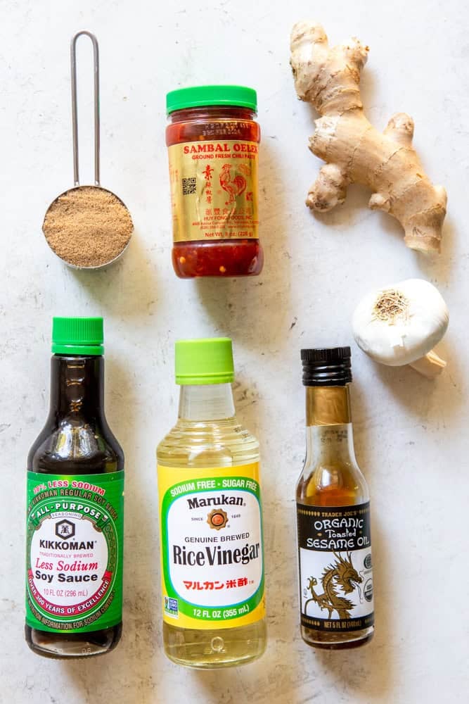 Ingredients for soy ginger marinade - low sodium soy sauce, rice vinegar, toasted sesame oil, brown sugar, Sambal Oelek, fresh ginger root and garlic.