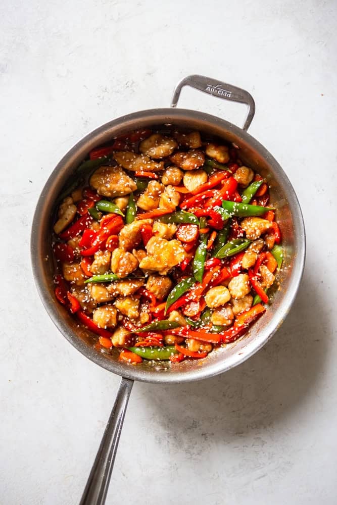 Finished honey garlic chicken stir fry in a pan.