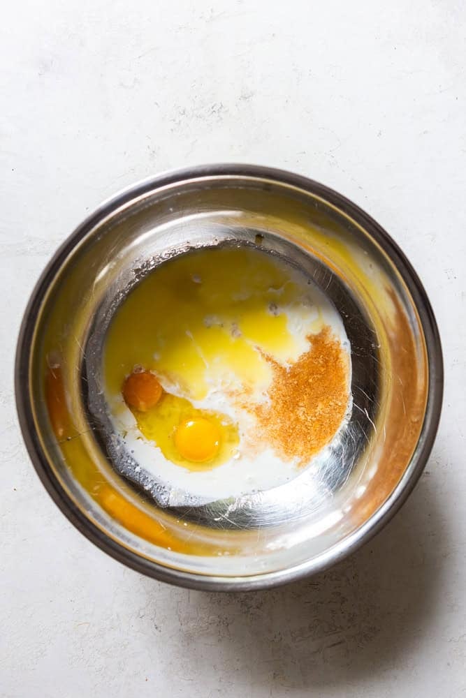 Wet ingredients for banana pancakes - mashed banana, buttermilk, eggs, melted butter, vanilla extract.