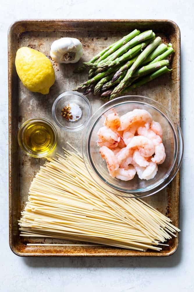Ingredients for Shrimp and asparagus pasta. Asparagus, lemon, garlic, olive oil, salt, red pepper flakes, shrimp, pasta.
